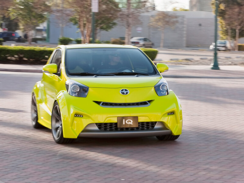 Yellow Toyota iQ in motion