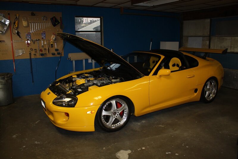 Yellow Toyota Supra in garage