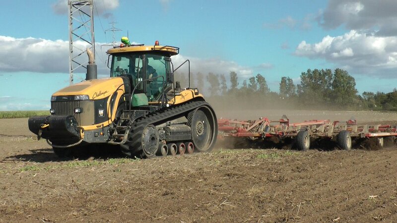 Yellow Tractor Plowing Field