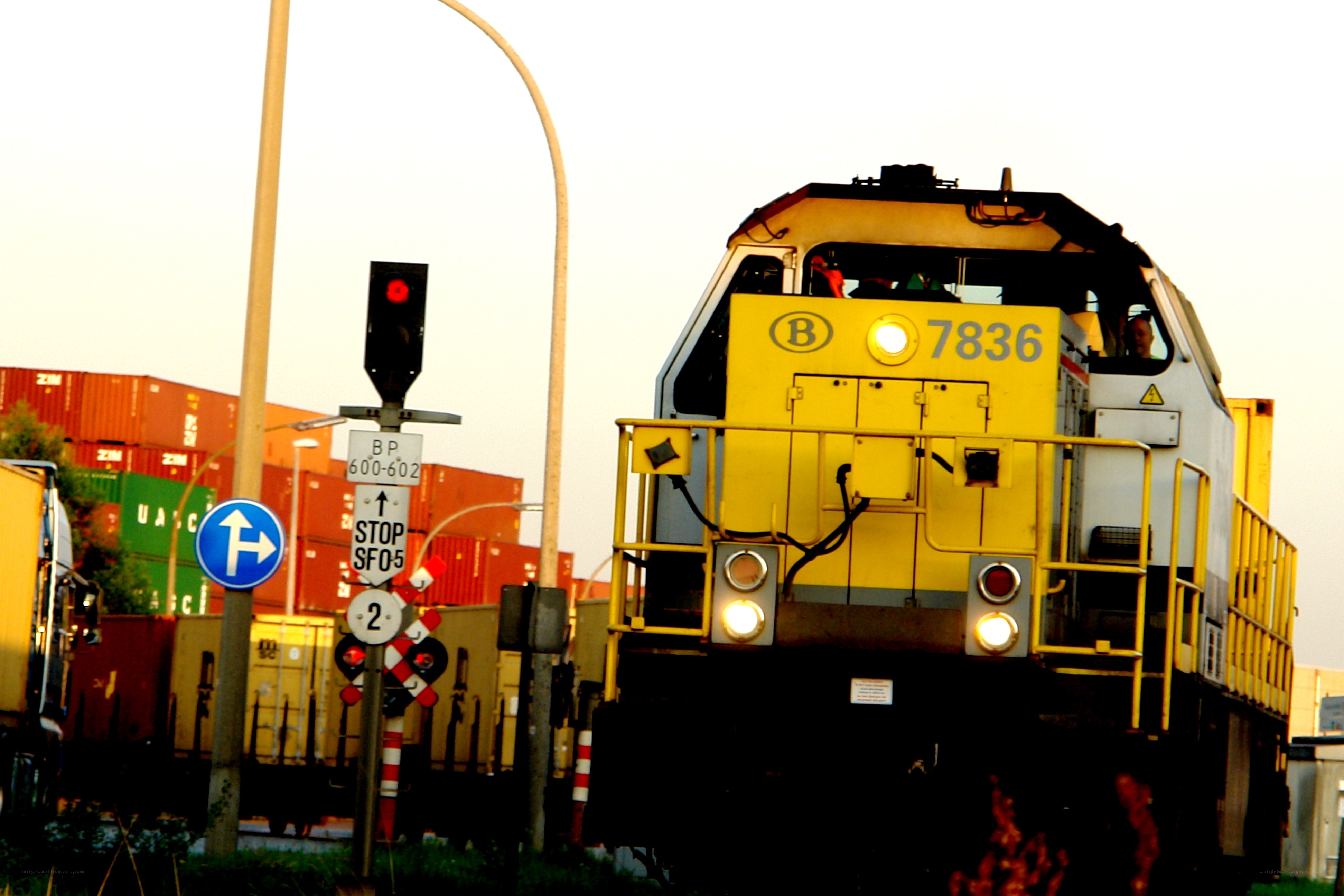Yellow train at a railway crossing