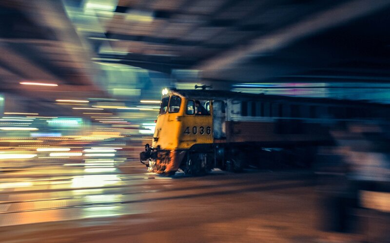 Yellow train in motion at night