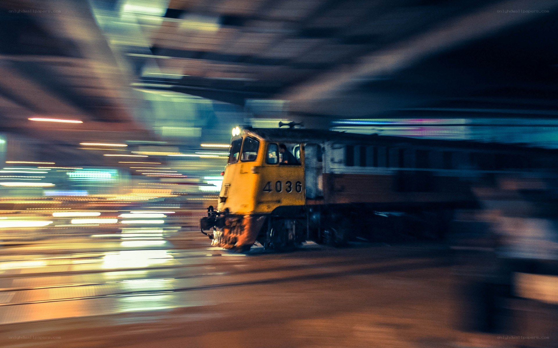 Yellow train in motion at night
