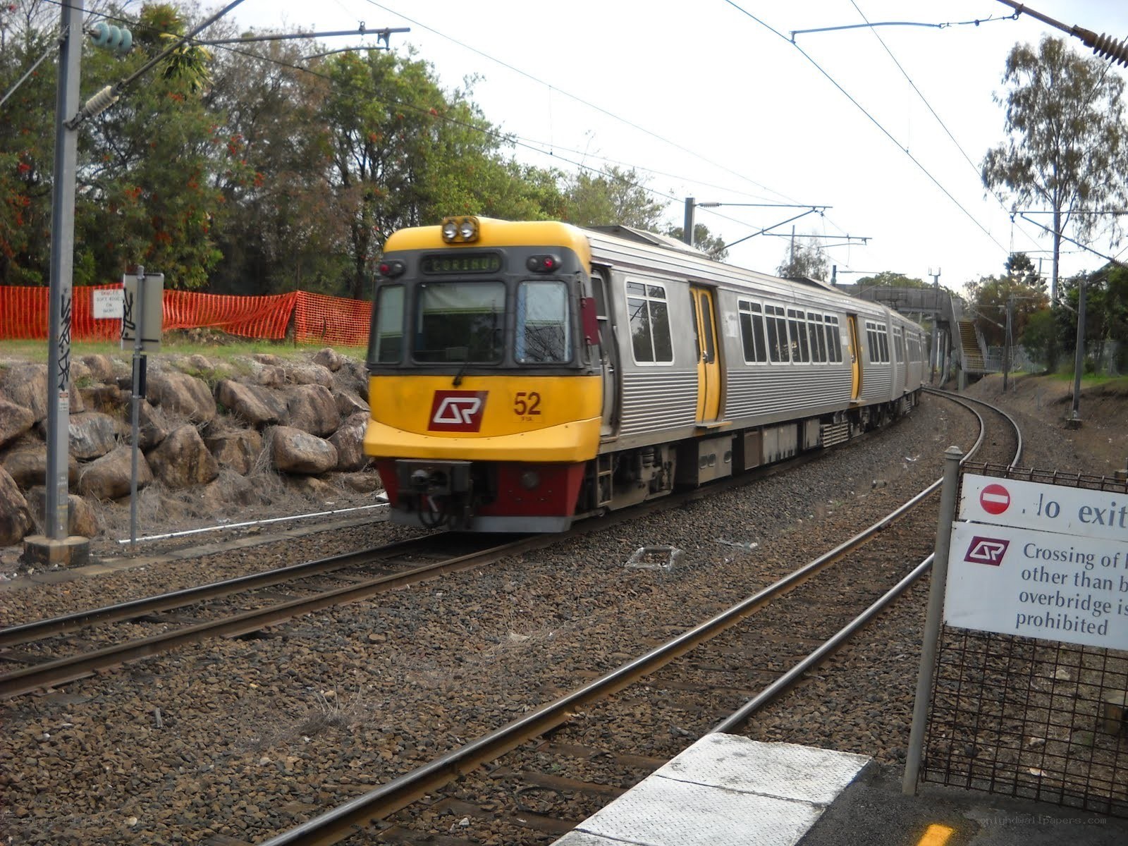 yellow train on curved track