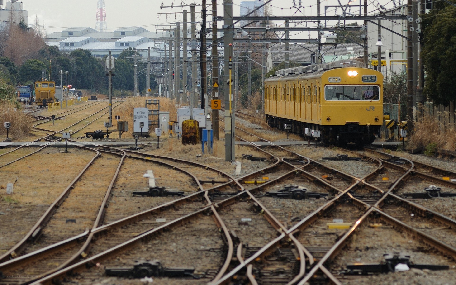 Yellow train on railway tracks