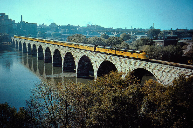 Yellow train on stone bridge
