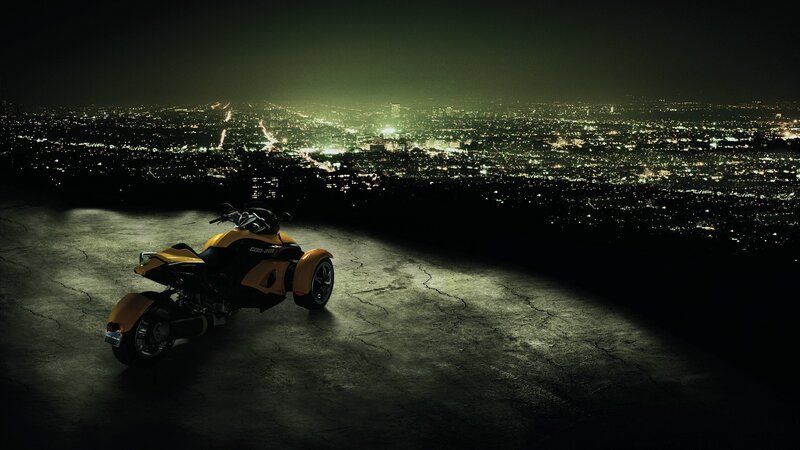 Yellow trike overlooking city at night