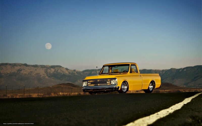 Yellow truck on road at dusk