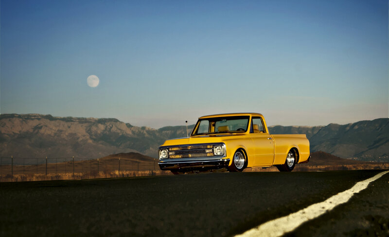 Yellow truck on road at dusk