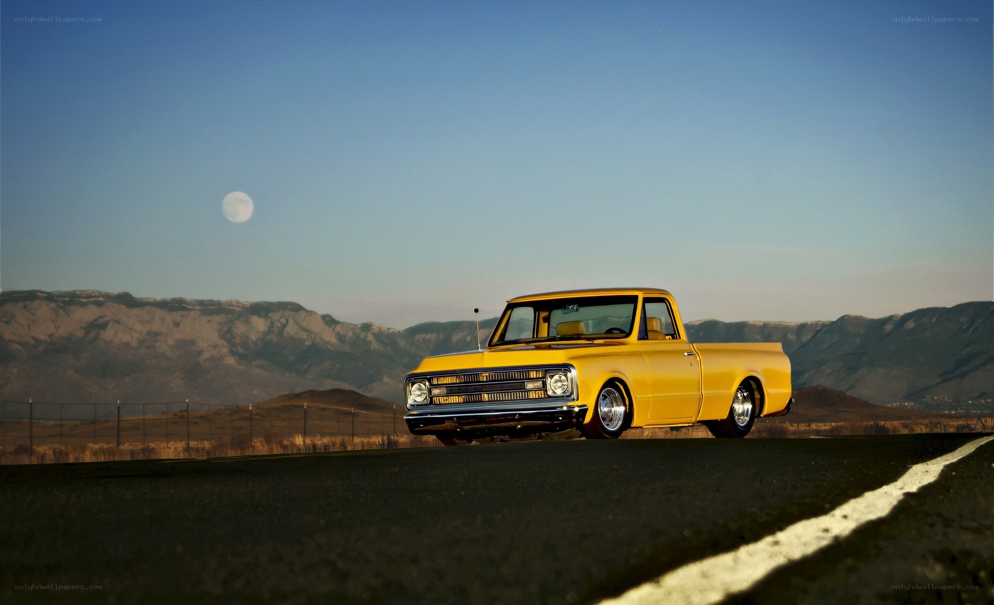 Yellow truck on road at dusk