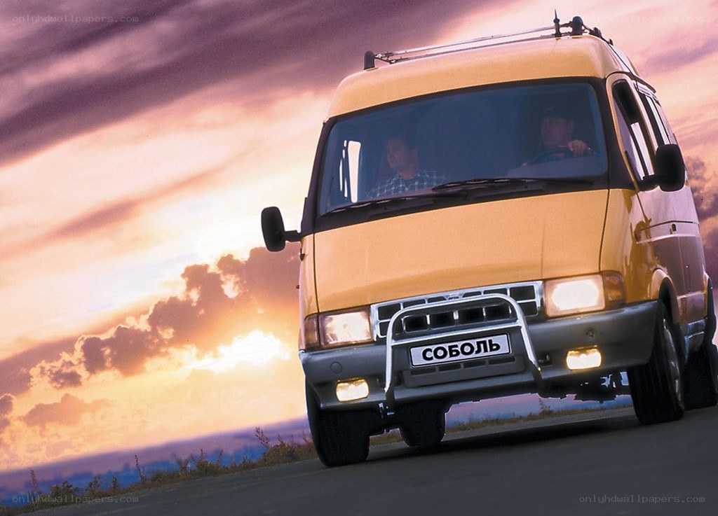 Yellow van on road at sunset