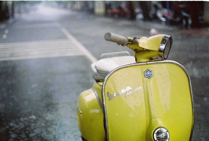 Yellow Vespa on a rainy street