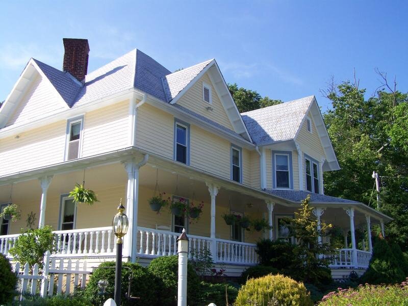 yellow victorian house with porch