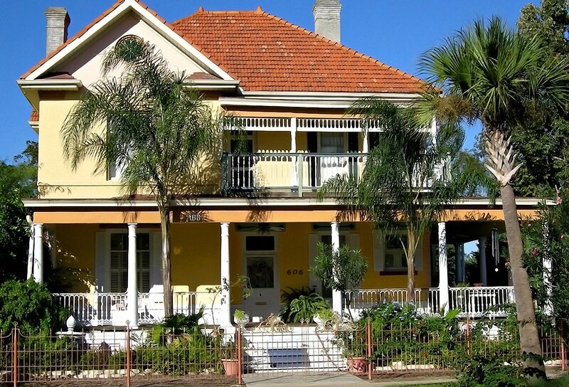yellow Victorian house with porch