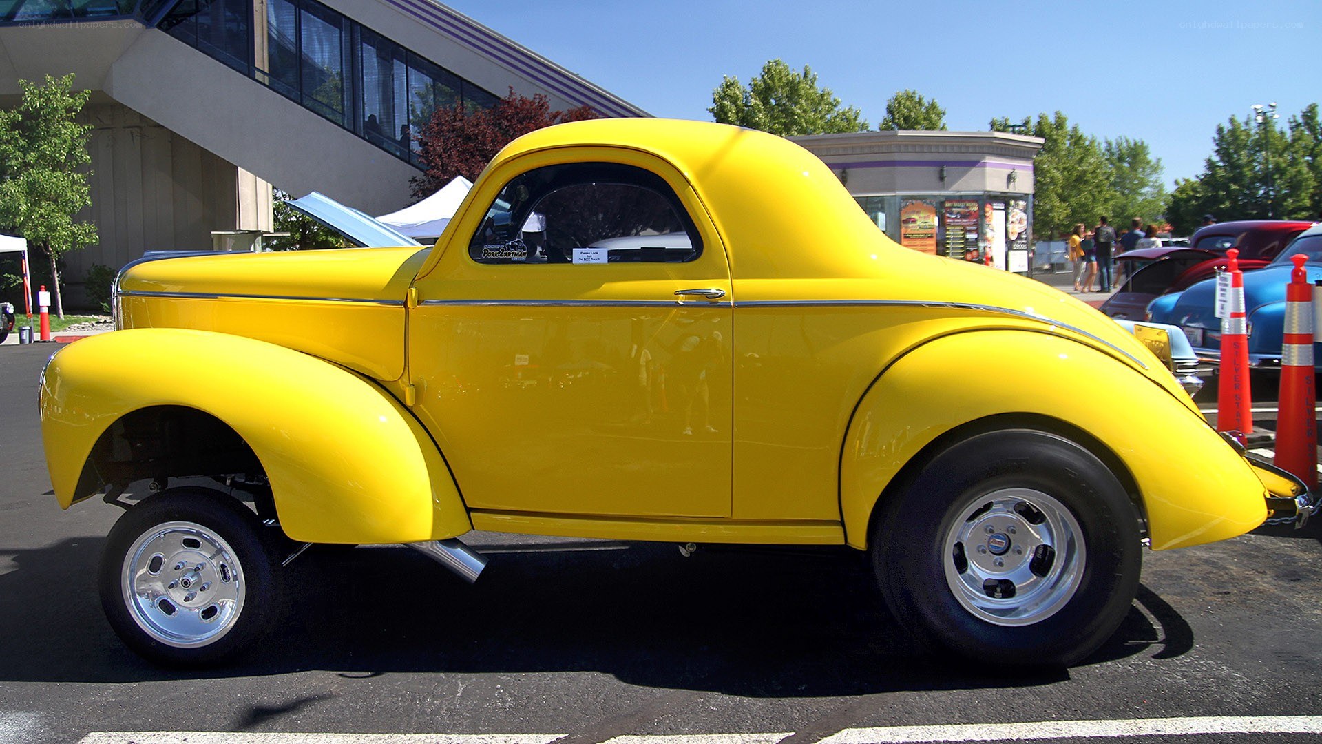 yellow vintage car at show