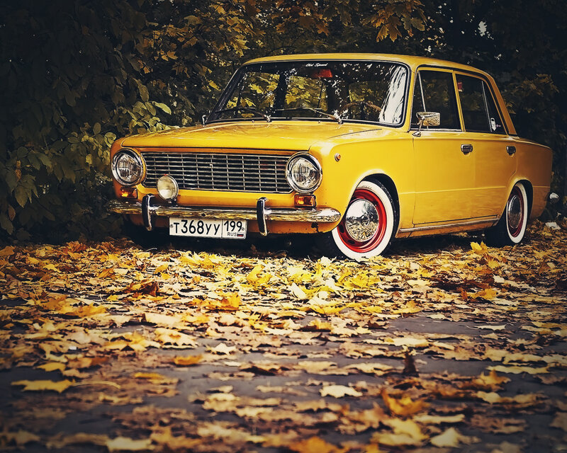 Yellow vintage car in autumn