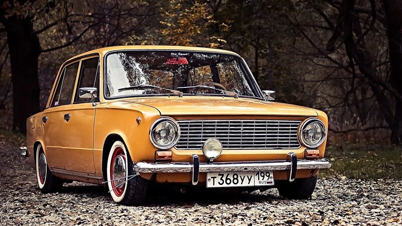 Yellow vintage car in forest