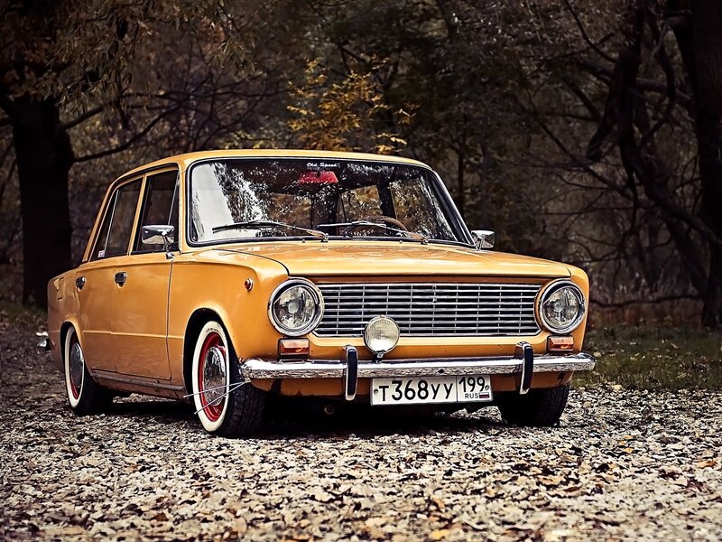 Yellow vintage car in forest