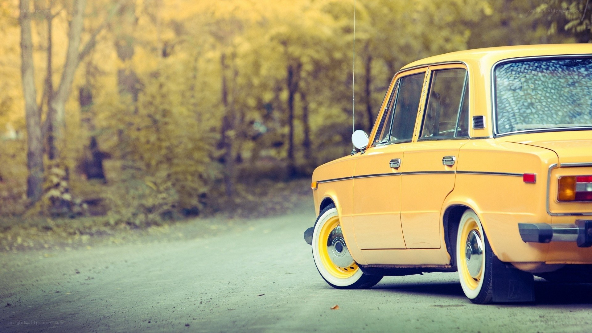yellow vintage car on a road
