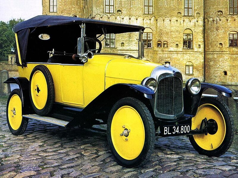 Yellow vintage car on cobblestones