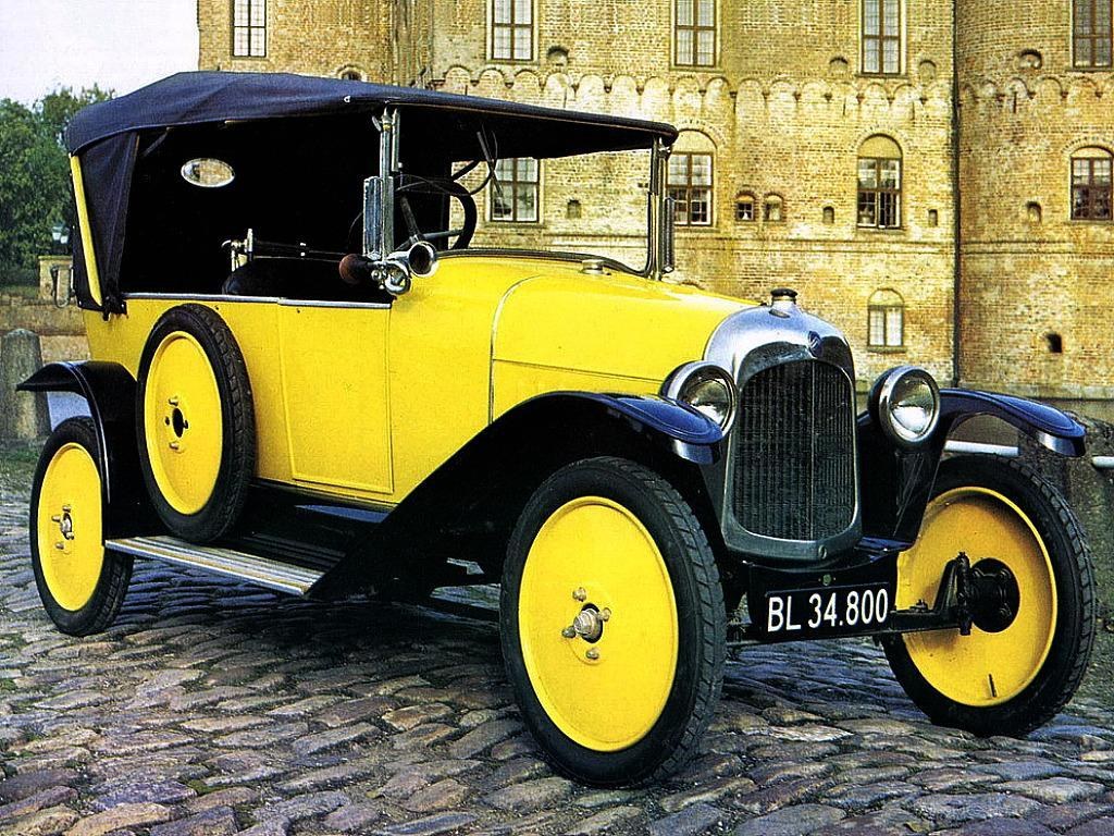 Yellow vintage car on cobblestones