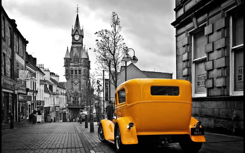 Yellow vintage car on street
