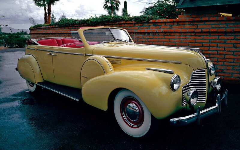 Yellow Vintage Convertible — Serene, Afternoon, Photograph, Brick Wall, Palm Trees
