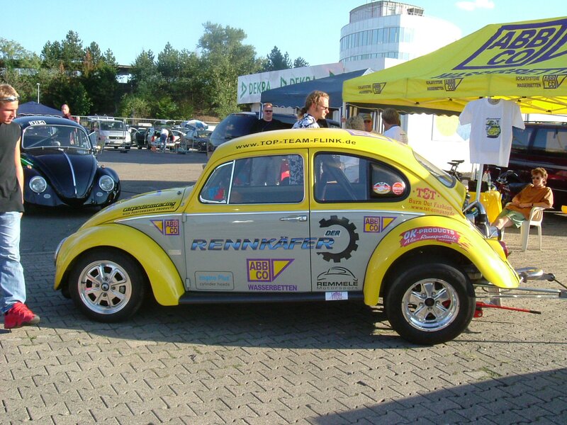 Yellow Volkswagen Beetle at a car show
