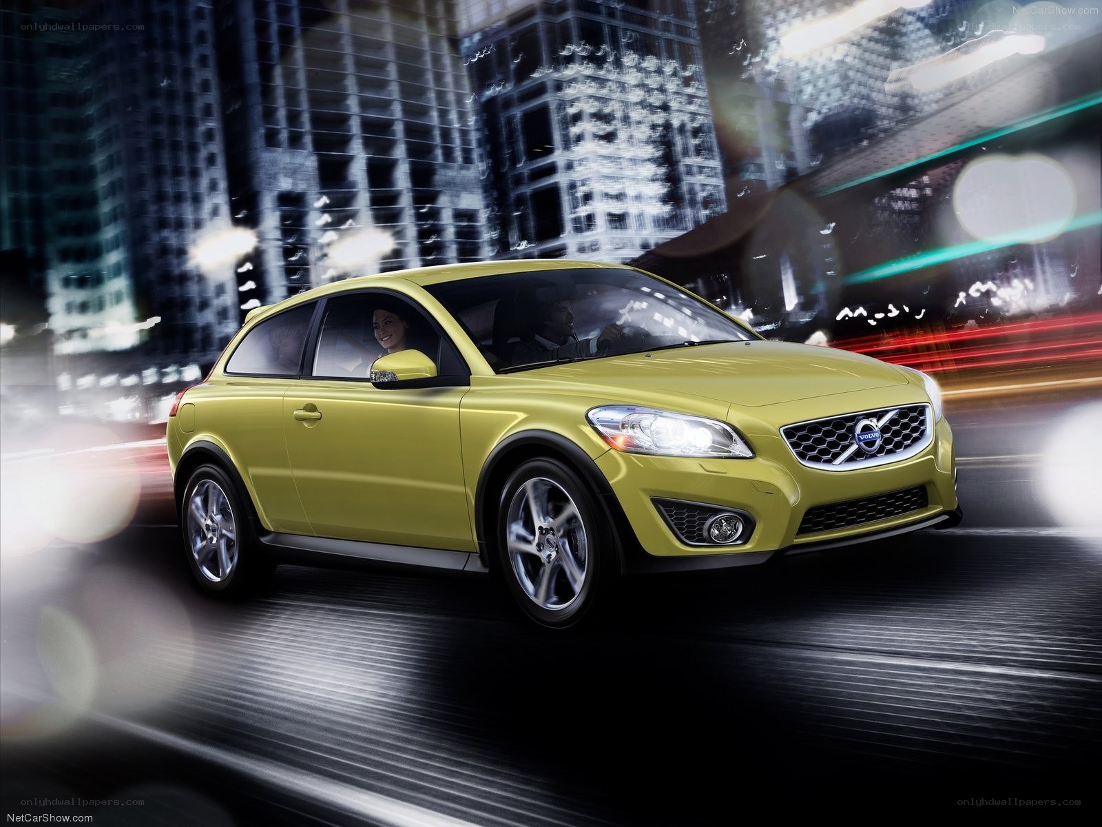 yellow volvo c30 driving at night