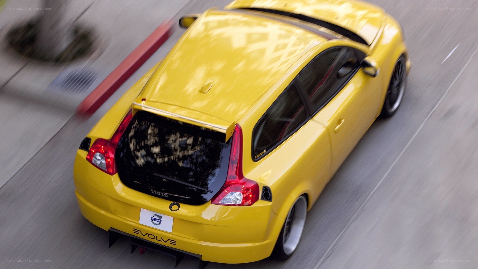 yellow volvo c30 in motion