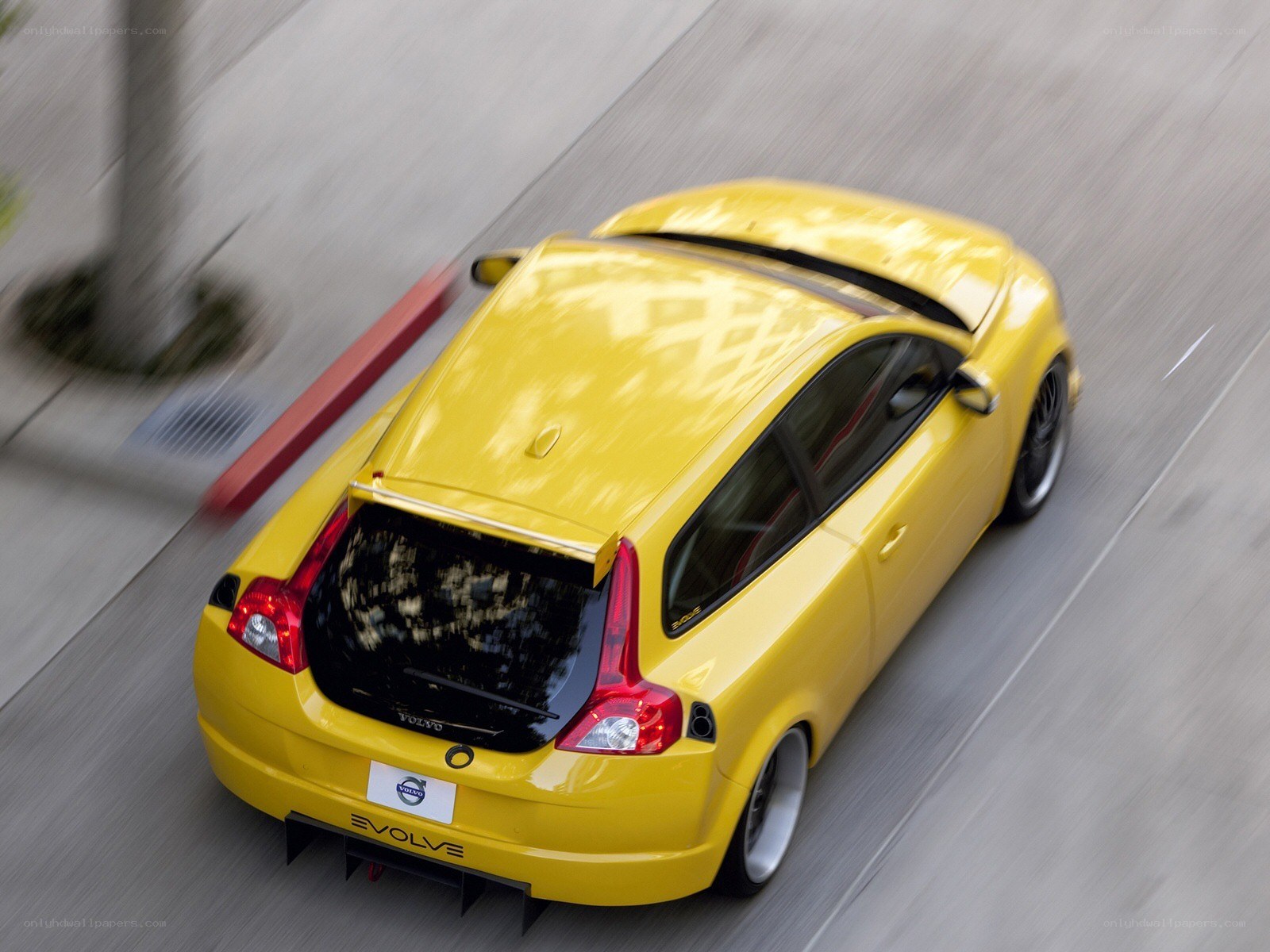 Yellow Volvo C30 in motion