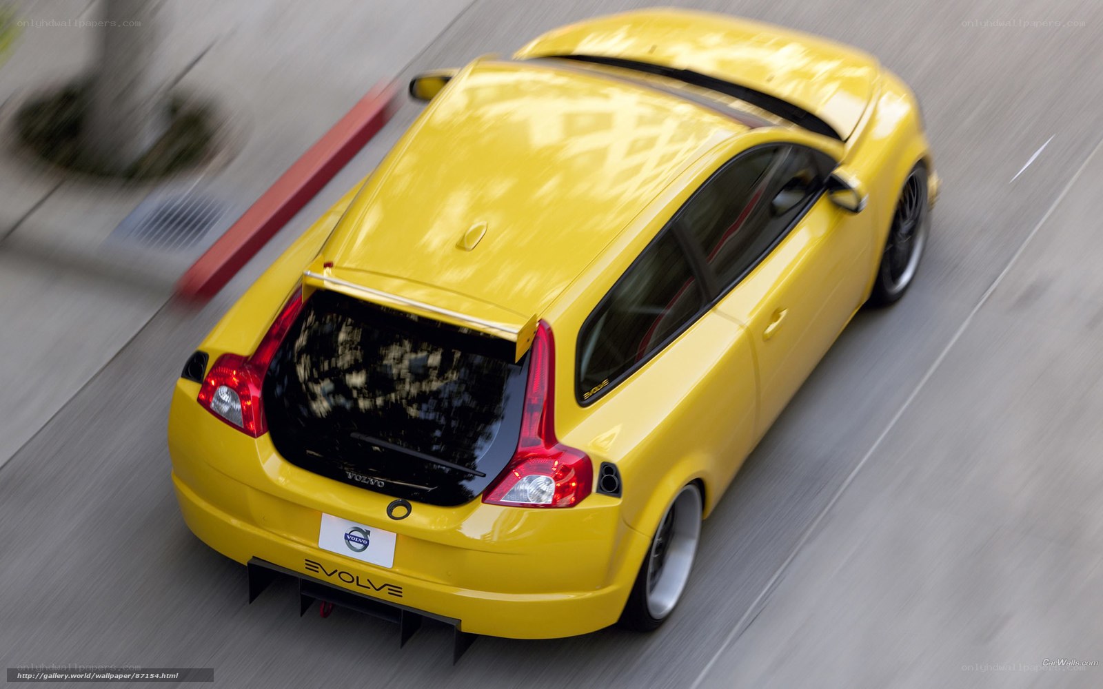 yellow volvo c30 in motion