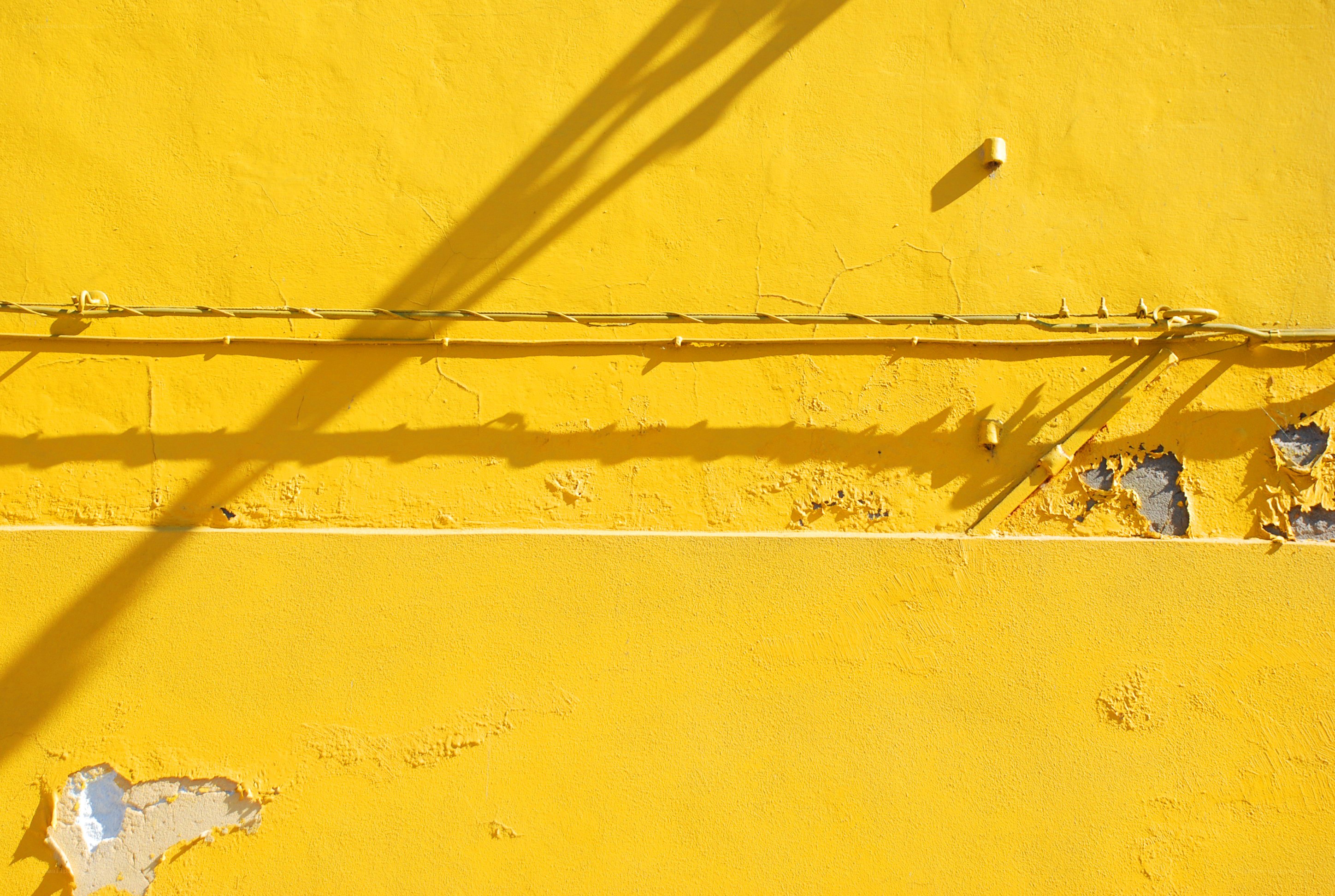 yellow wall with cable shadows