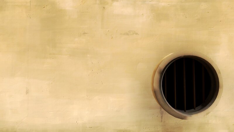 yellow wall with circular vent