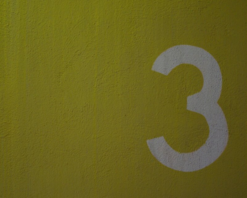 yellow wall with number three