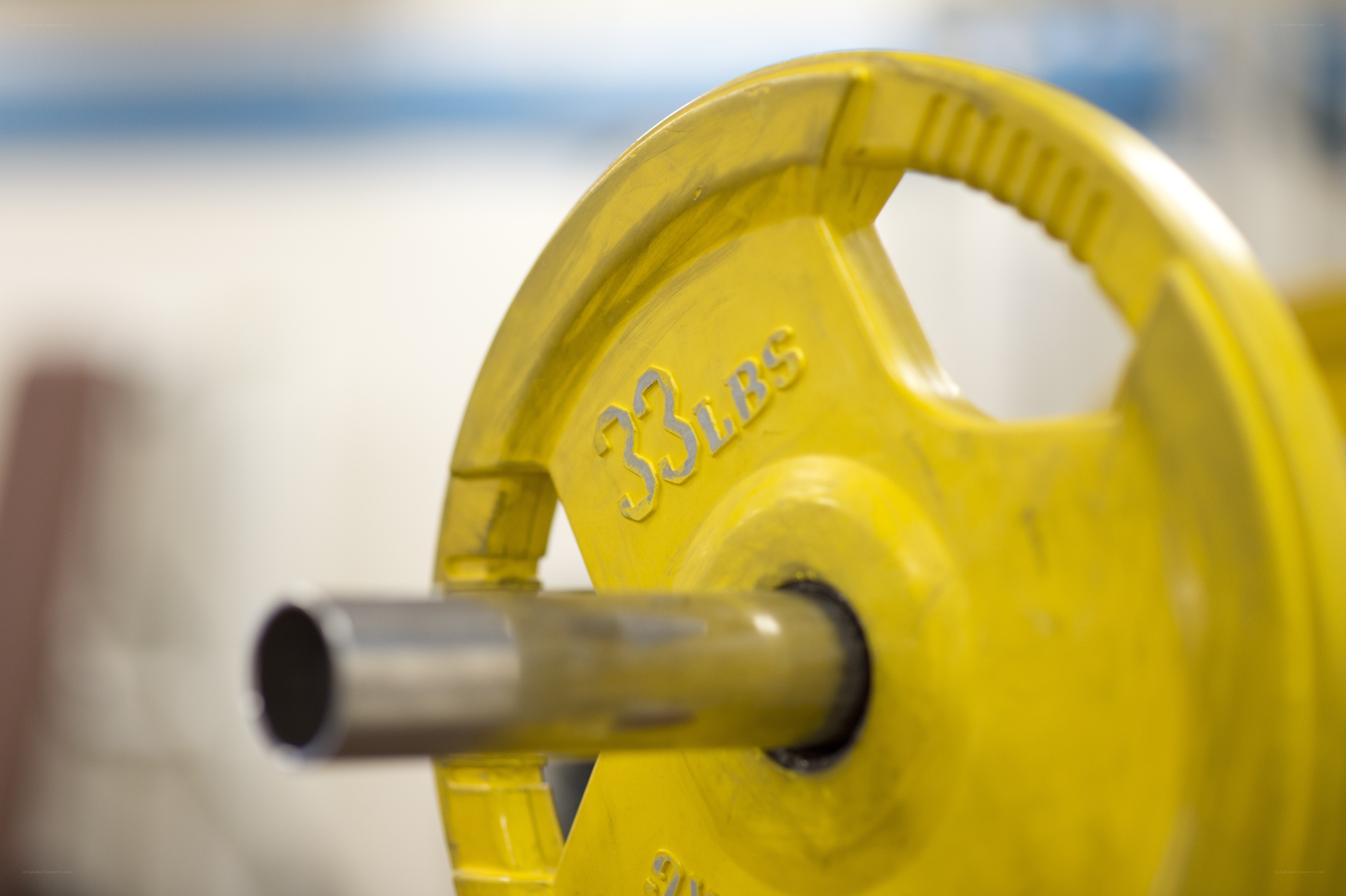 yellow weight plate on barbell