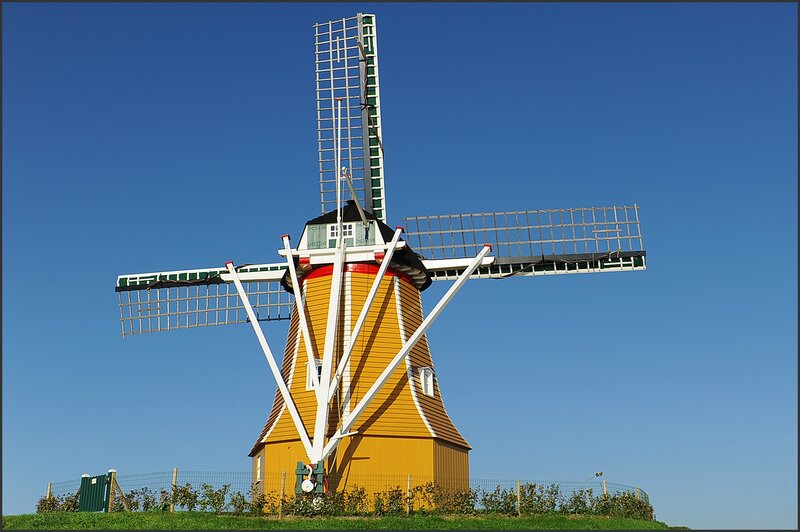 Yellow windmill under blue sky