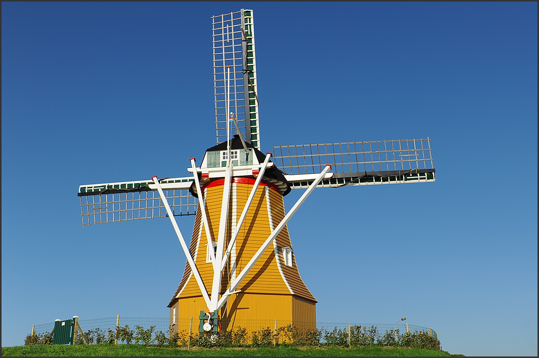 Yellow windmill under blue sky