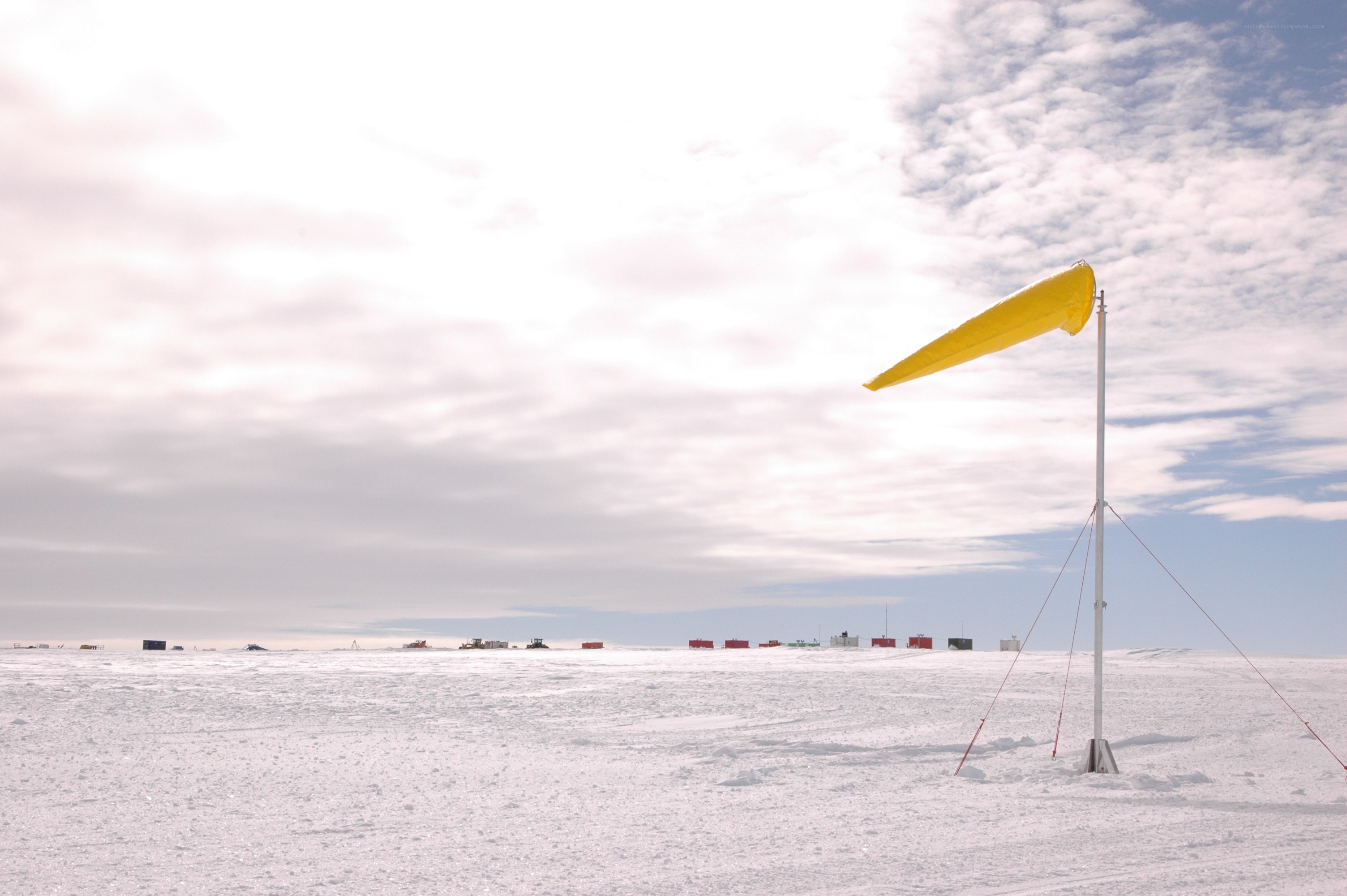 Yellow windsock on snowy plain