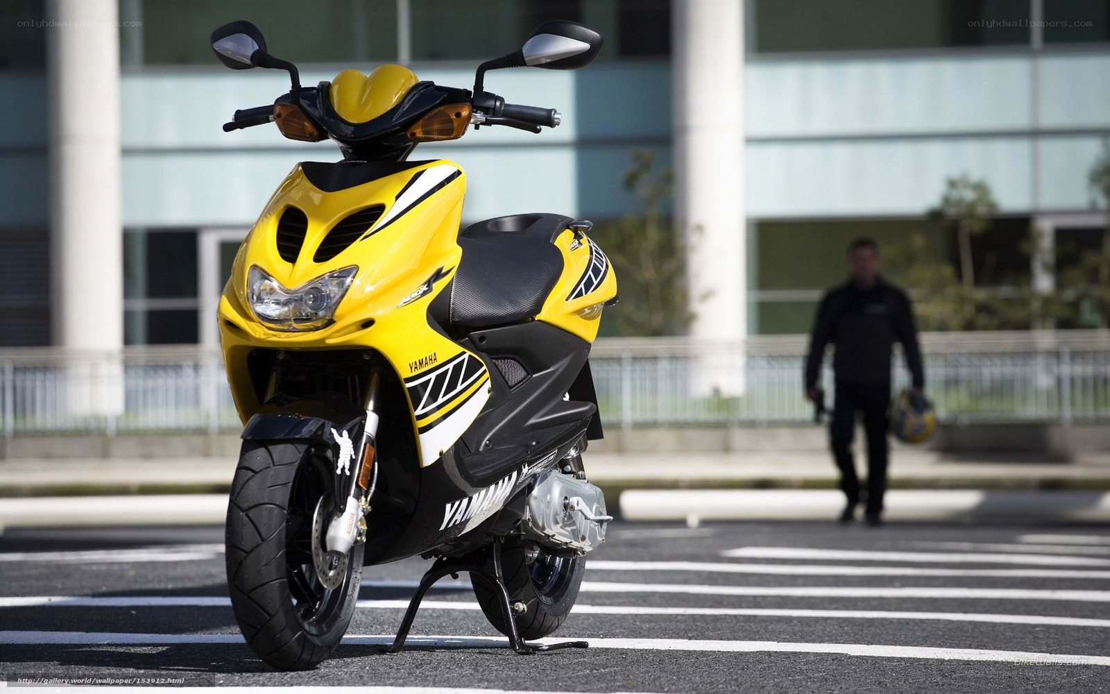 Yellow Yamaha scooter on street