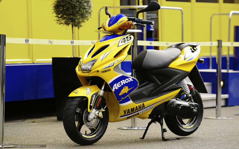 Yellow Yamaha scooter with racing decals