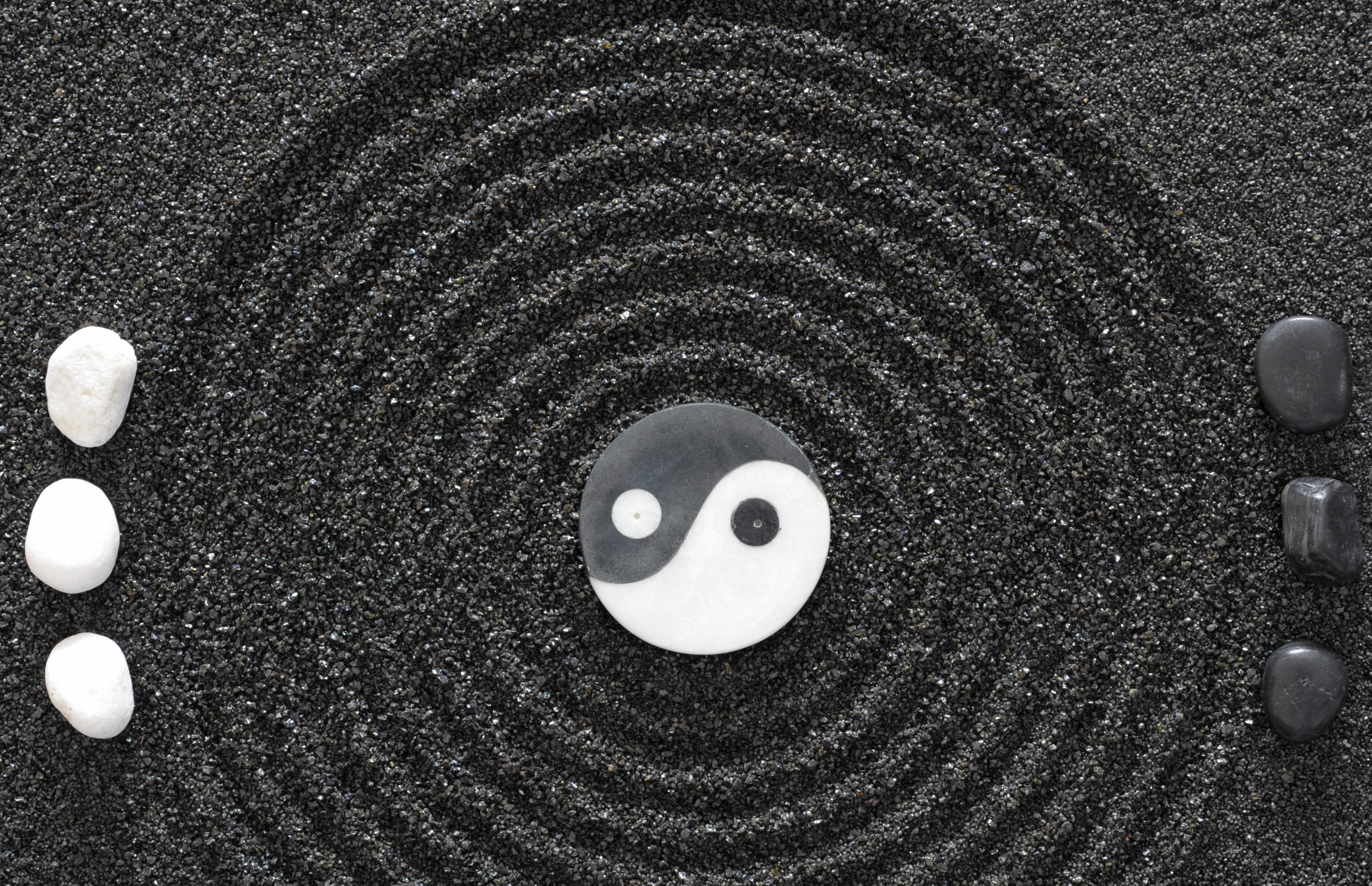Yin-yang symbol in sand