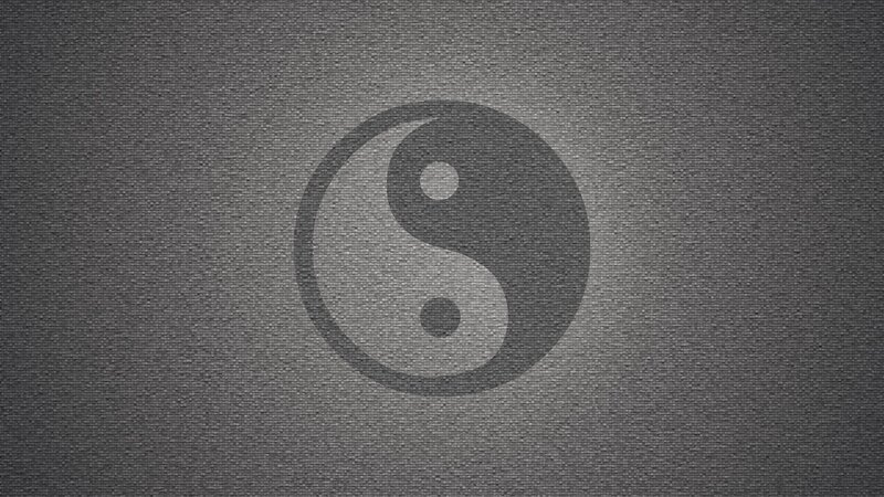Yin-yang symbol on textured background