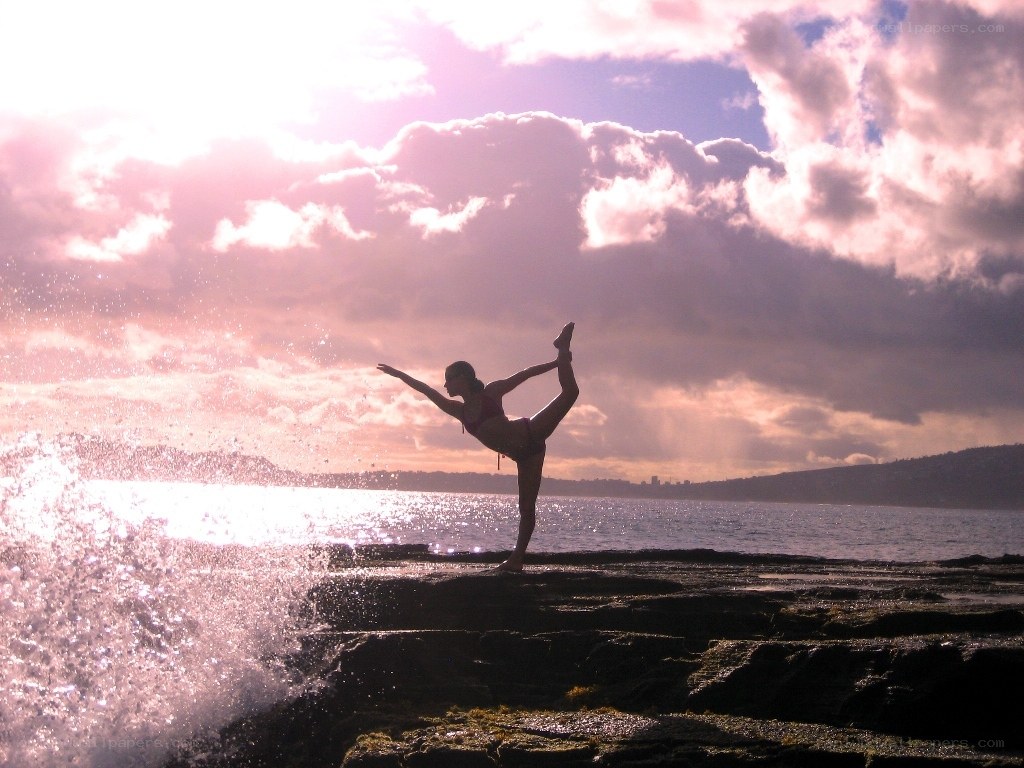 Yoga at sunset by the sea