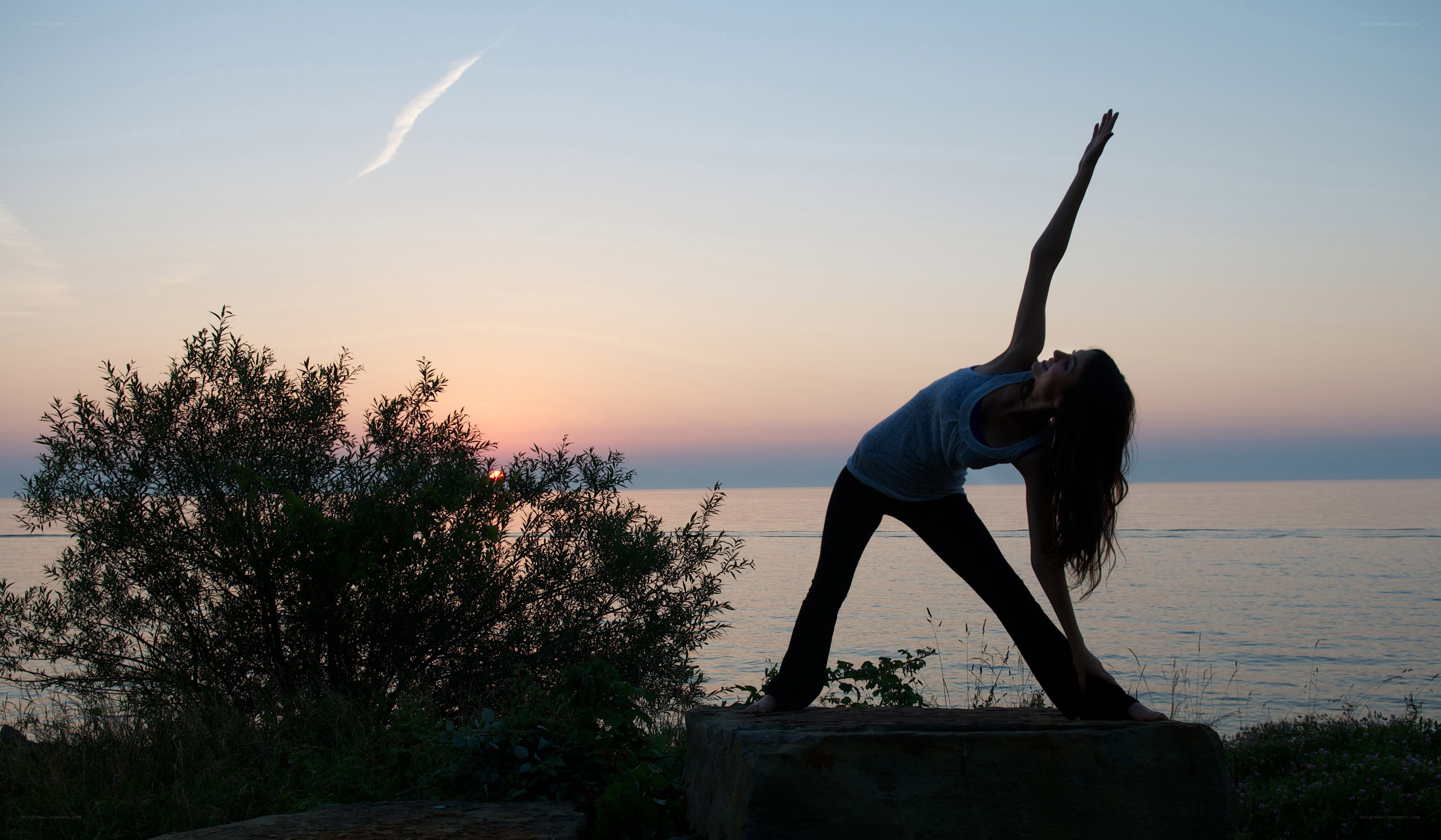 Yoga at sunset by the water
