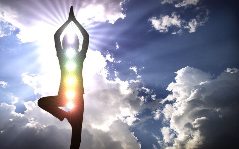Yoga silhouette with chakras