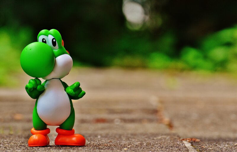 Yoshi figurine on pavement