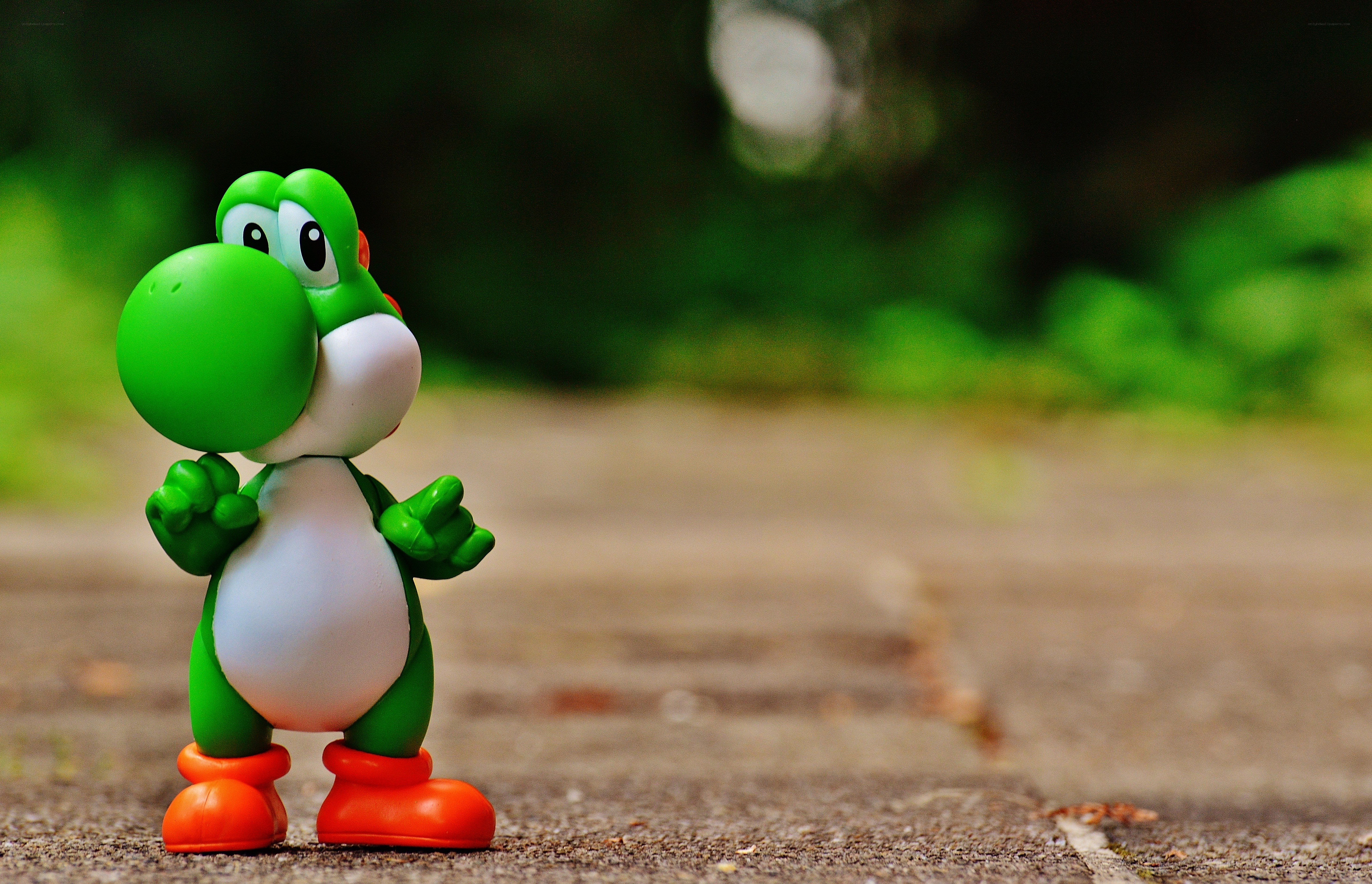 Yoshi figurine on pavement