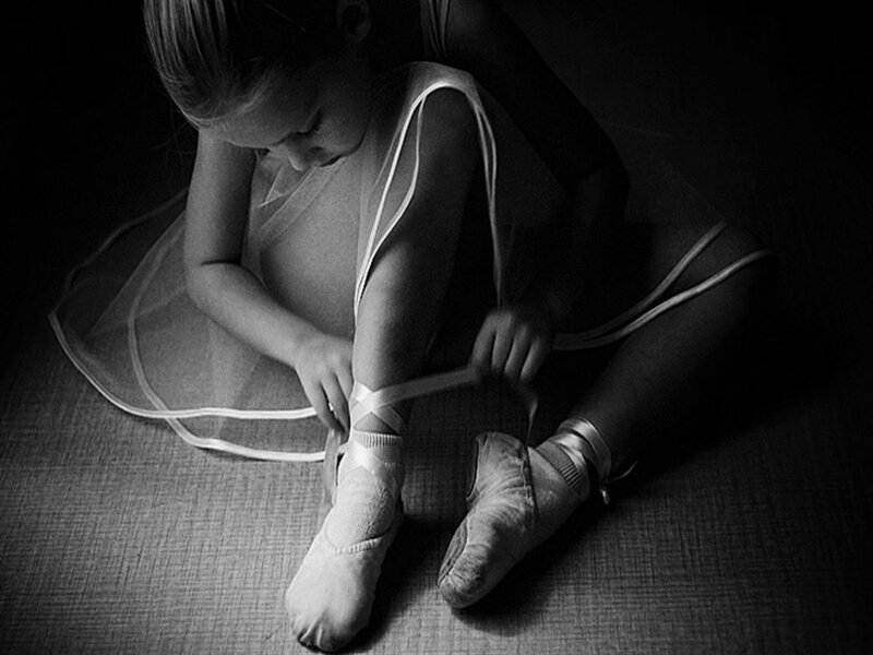 Young Ballerina Tying Shoes — Black