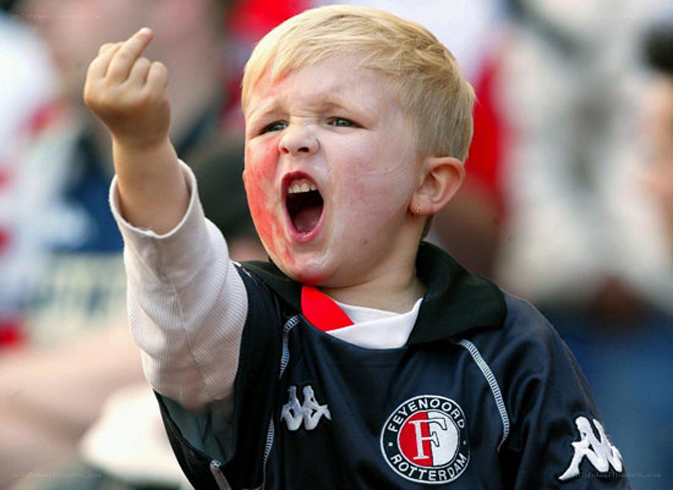 young boy cheering at a game