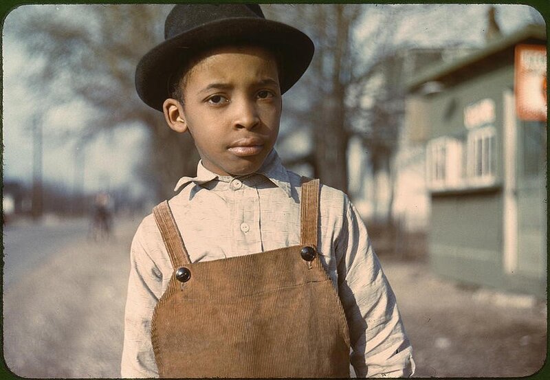 Young boy in overalls and hat
